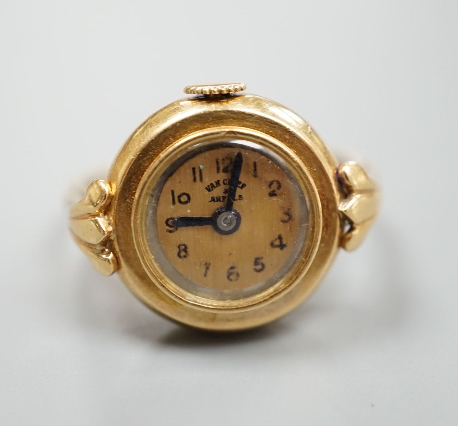 A yellow metal ring watch, the dial inscribed 'Van Cleef & Arpels', size N/O, gross 8.2 grams.